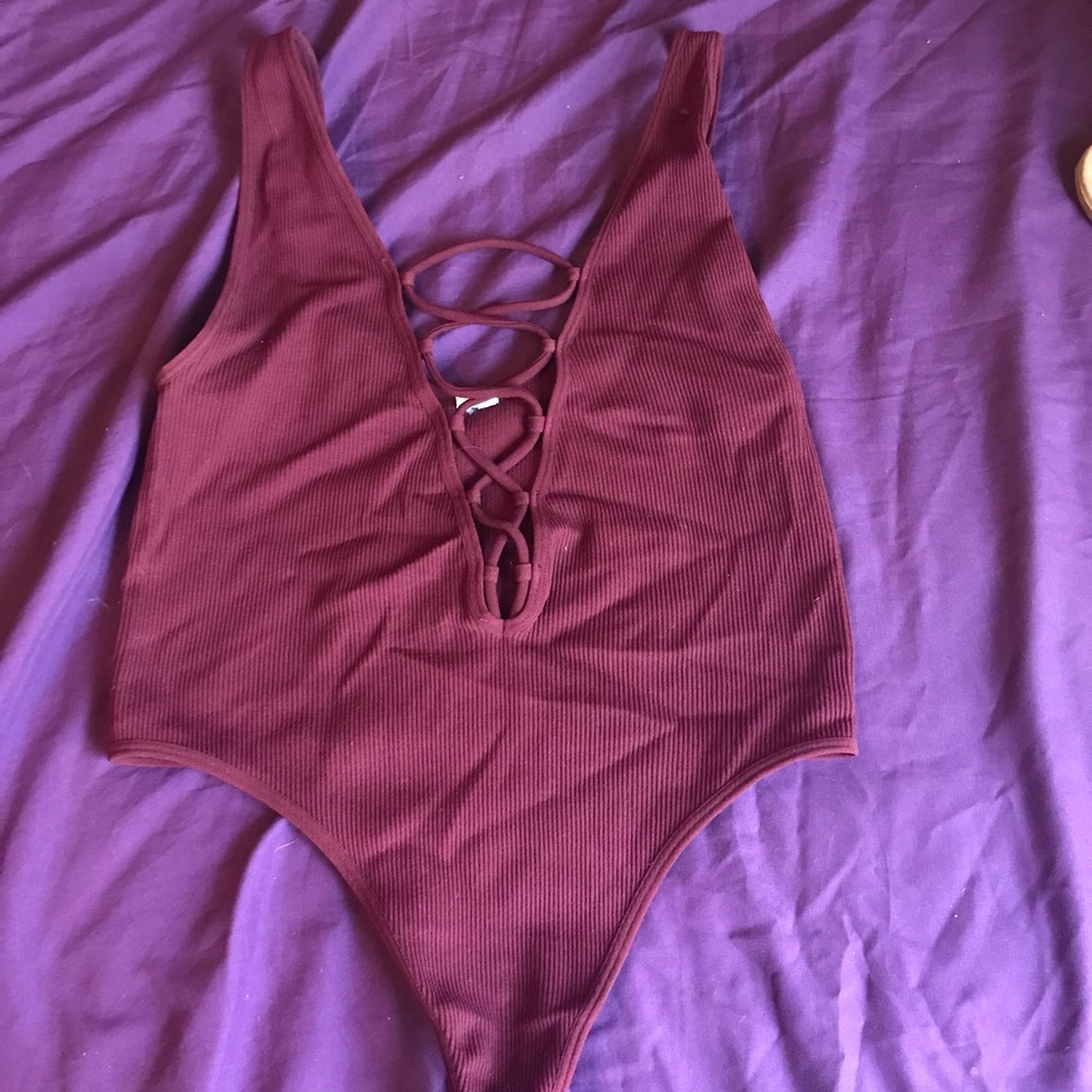 Burgundy tie up bodysuit.